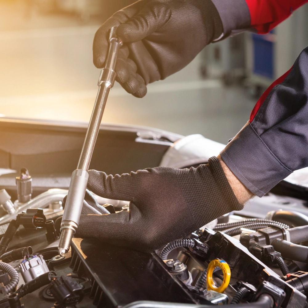 A person working on an engine in a garage.