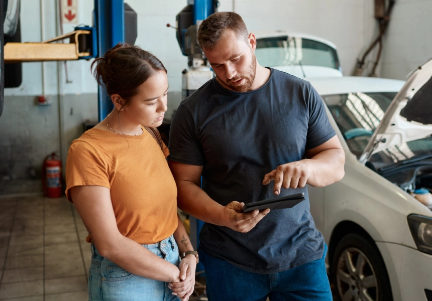 A man and woman looking at an ipad.